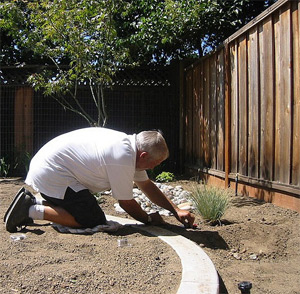 a tech is installing the new drip irrigation system